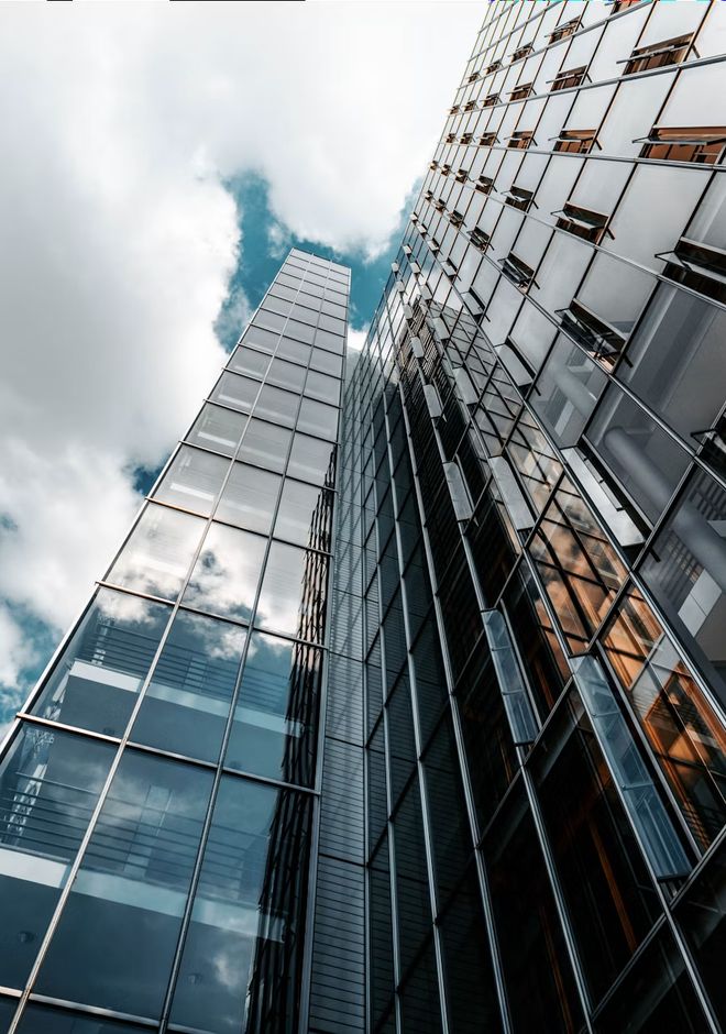 A glass skyscraper seen from street level